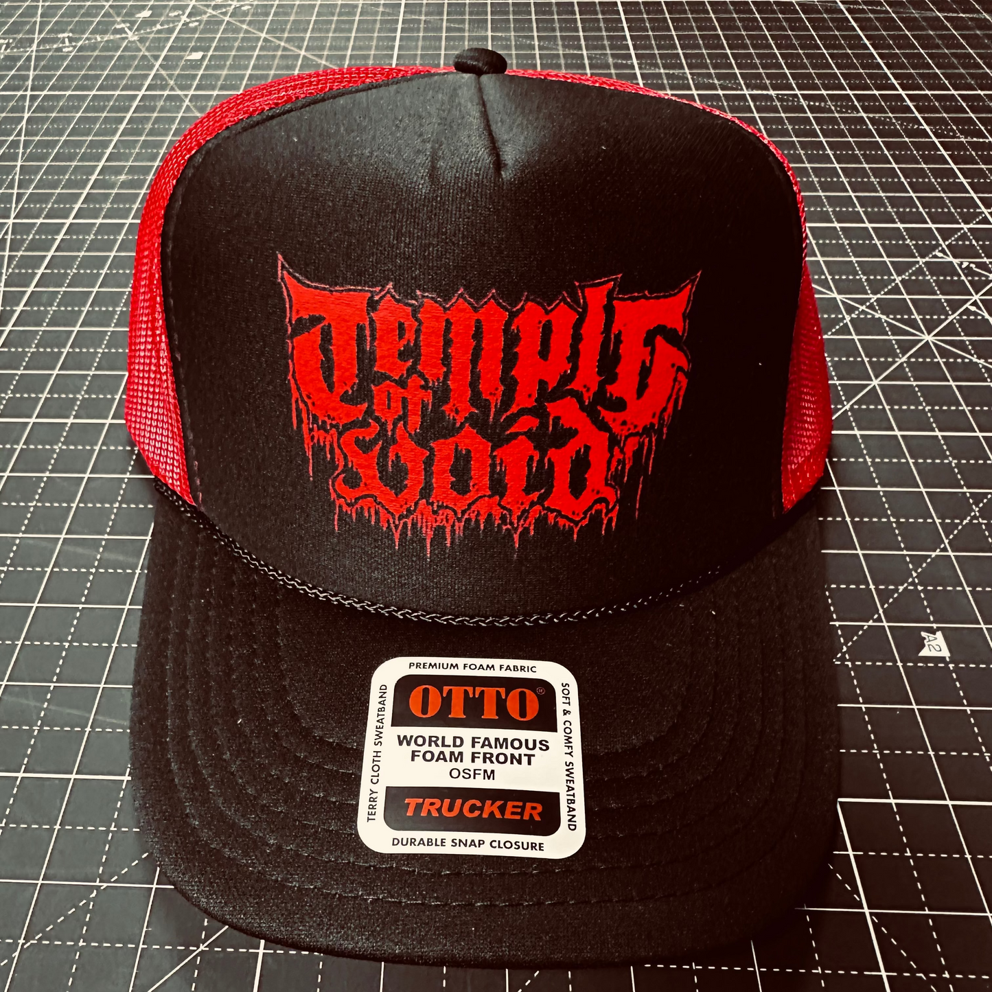 Black and red cap with 'Temple of Void' logo on a grid background