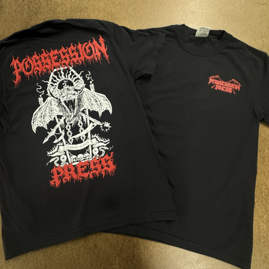 Black t-shirt with graphic design and 'Possession Press' text on a beige surface