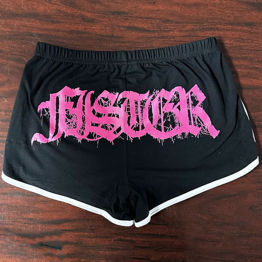 Black shorts with pink "Fister" text on a wooden surface