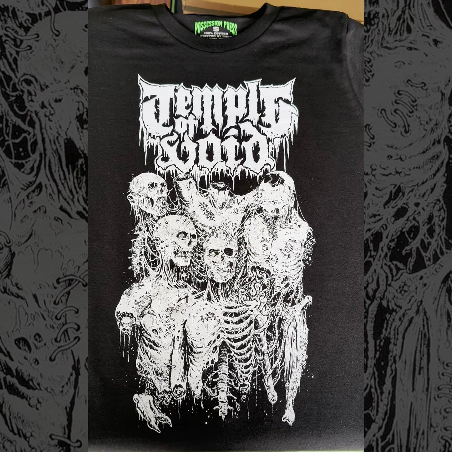 Black t-shirt with white graphic design of skeletons and text on a dark background