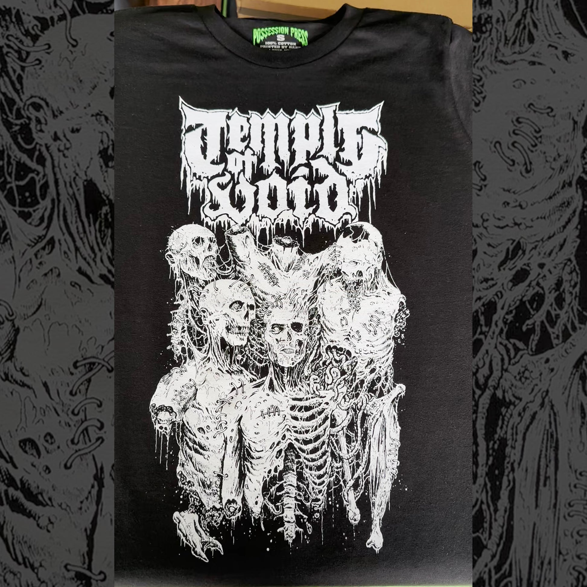 Black t-shirt with white graphic design of skeletons and text on a dark background