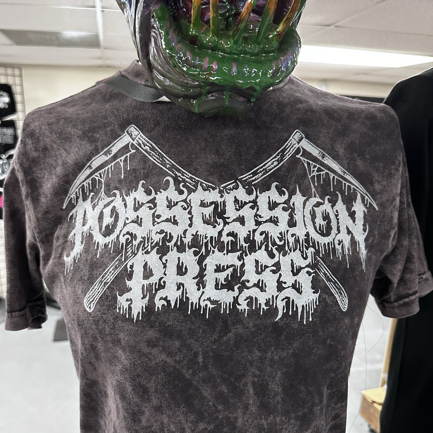 Cloud black t-shirt with white graphic design and text, worn by a mannequin wearing a green mask.